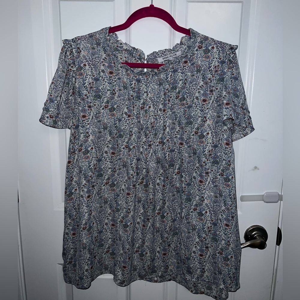 Short sleeve dressy shirt with bottom enclosure in back. Cute pattern!